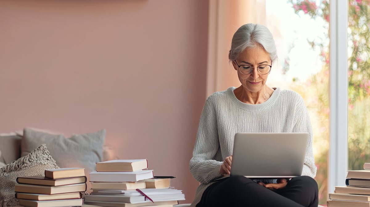 Senior Older Retired Woman Grandmother Working On Laptop Writing And Working On Her Book